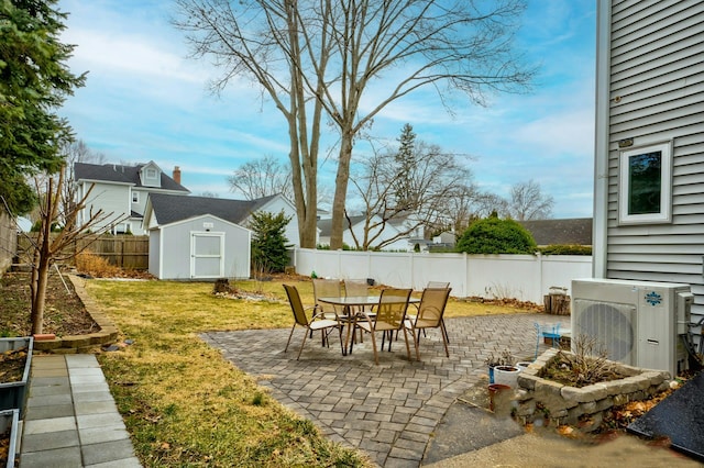 view of patio / terrace featuring a storage unit, ac unit, an outdoor structure, and a fenced backyard