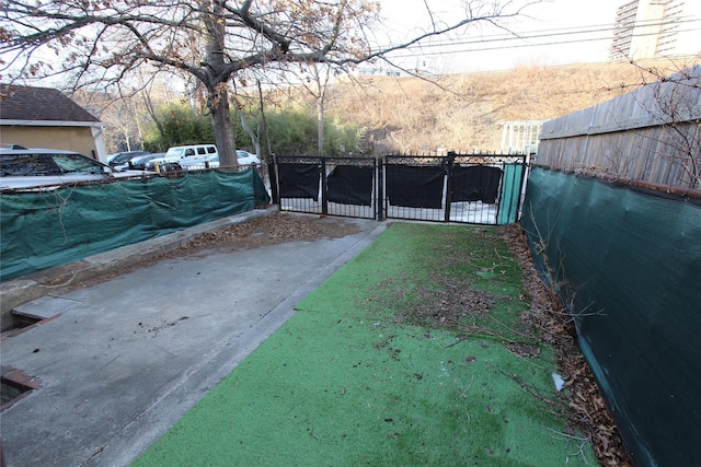 view of yard with fence and a gate