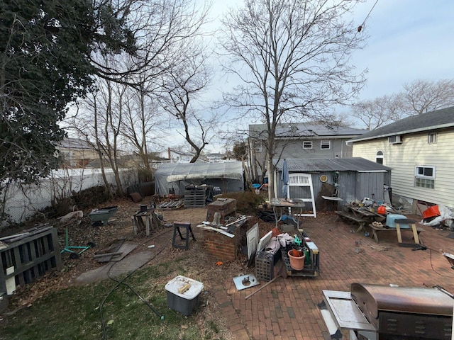 view of yard with a storage shed, fence, and an outdoor structure