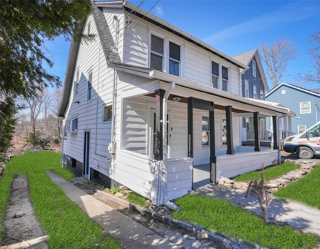 view of front of home with a shingled roof and covered porch