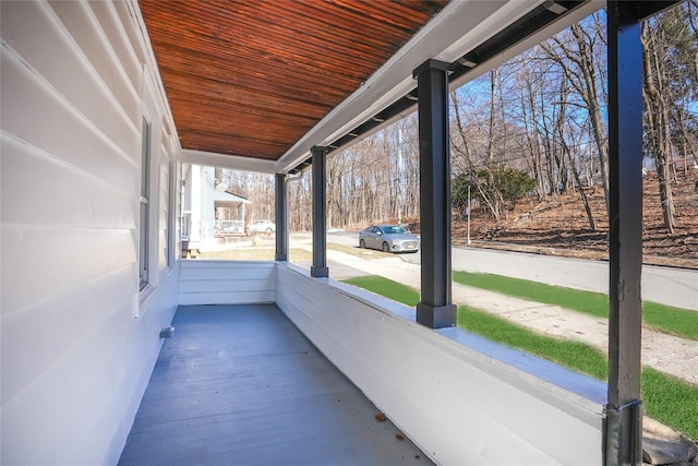 unfurnished sunroom with wooden ceiling