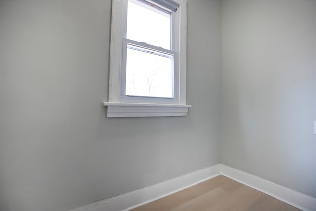 empty room with baseboards and wood finished floors