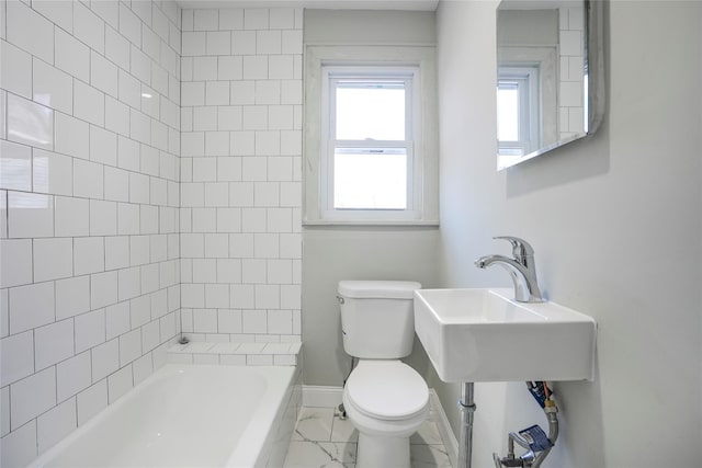 full bathroom with marble finish floor, shower / bath combination, toilet, a sink, and baseboards