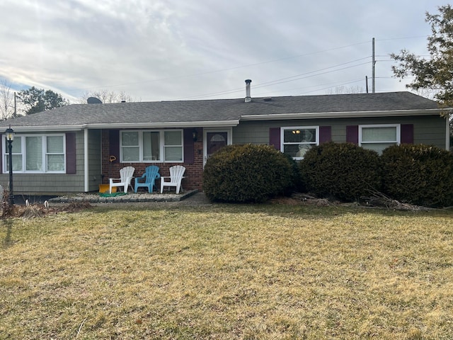 single story home with a shingled roof, brick siding, and a front lawn