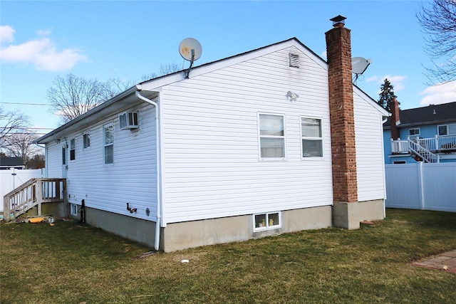 view of property exterior with a wall mounted air conditioner and a yard