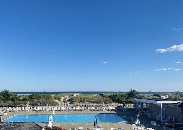 view of swimming pool with a water view