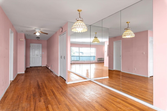 hall with hardwood / wood-style flooring and baseboards