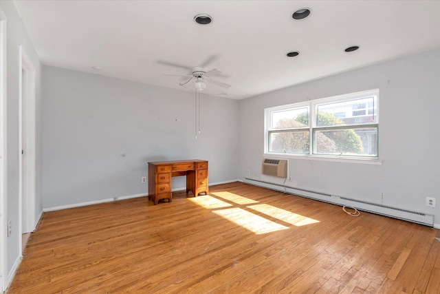 unfurnished room featuring a baseboard radiator, a ceiling fan, baseboards, an AC wall unit, and light wood finished floors