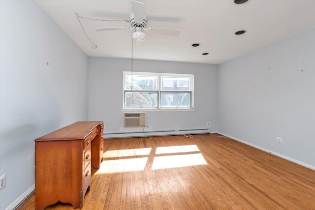 unfurnished room featuring ceiling fan, a wall unit AC, baseboards, light wood-style floors, and baseboard heating