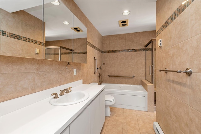 bathroom with tile patterned flooring, toilet, tile walls, a bath, and walk in shower