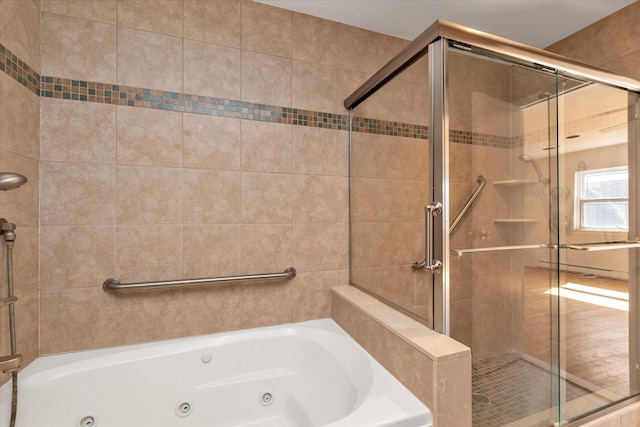 bathroom with a jetted tub and a shower stall