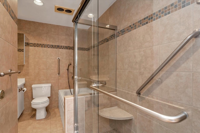 bathroom with tile patterned flooring, toilet, a washtub, tile walls, and a shower stall