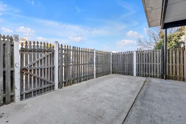 view of patio with a gate and fence