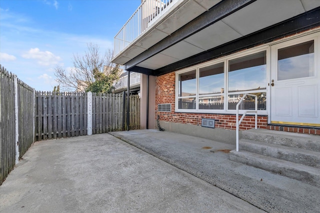 view of patio featuring entry steps and fence