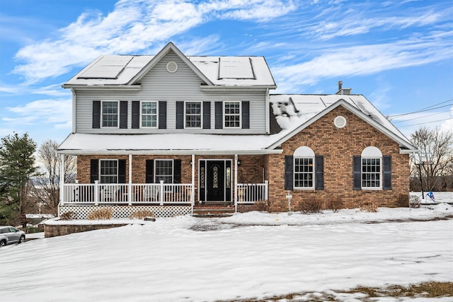 traditional home with a porch and brick siding