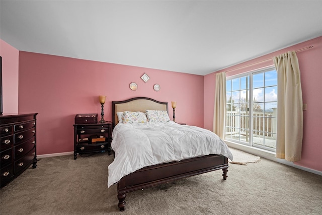 bedroom with carpet, baseboards, and access to outside