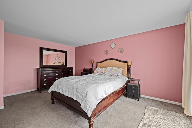 bedroom featuring baseboards and light colored carpet