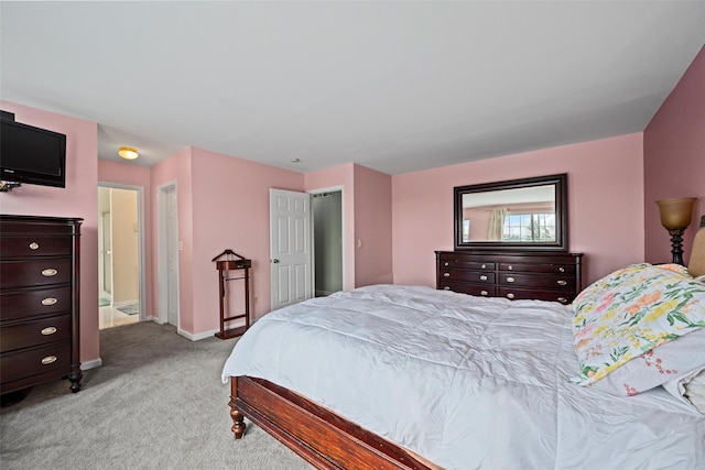 bedroom with light carpet and baseboards