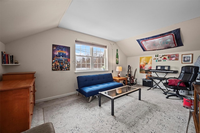 living area featuring lofted ceiling and baseboards