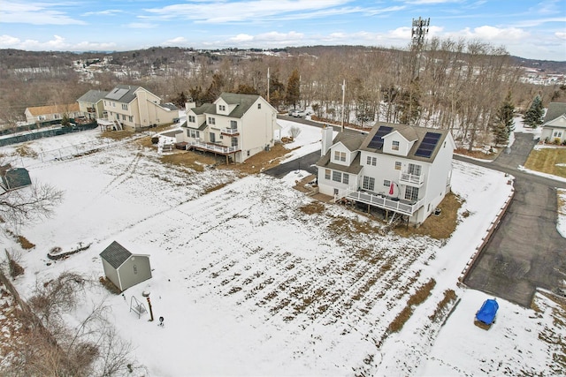 snowy aerial view with a residential view