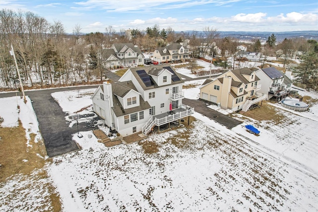 snowy aerial view featuring a residential view