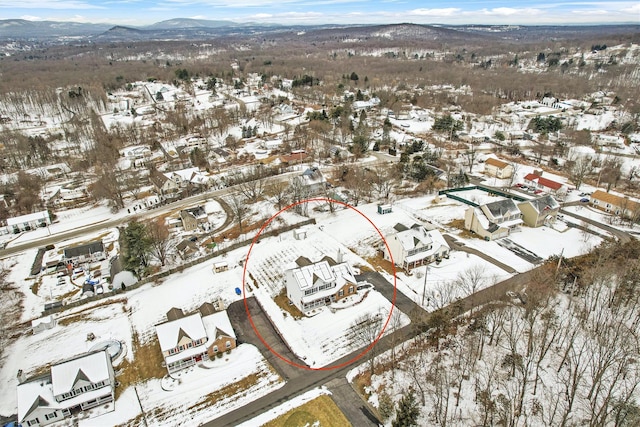 snowy aerial view with a residential view and a mountain view