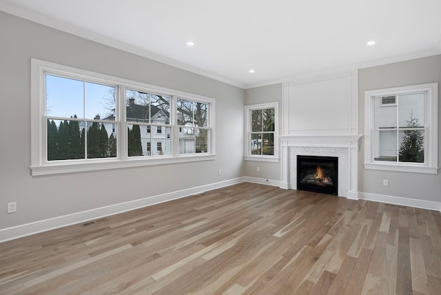 unfurnished living room featuring light wood-type flooring, baseboards, and visible vents