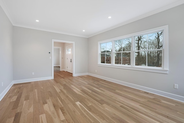 spare room with light wood-style floors, recessed lighting, crown molding, and baseboards