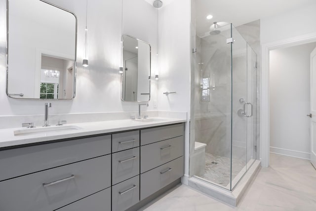 full bathroom with double vanity, a stall shower, marble finish floor, and a sink