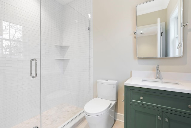 bathroom featuring vanity, a shower stall, and toilet