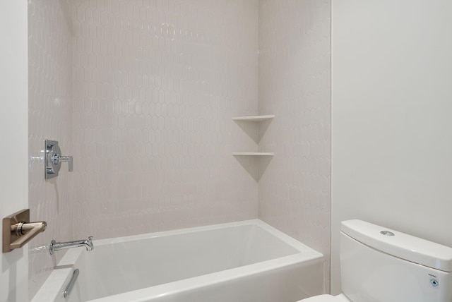 bathroom featuring bathtub / shower combination and toilet