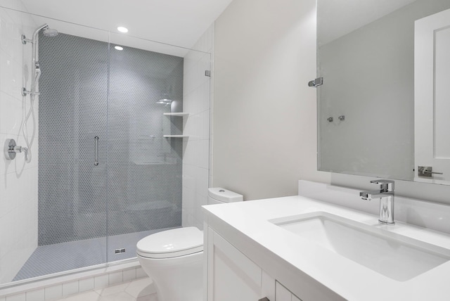 full bathroom with a stall shower, vanity, toilet, and tile patterned floors