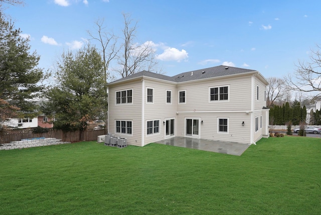 rear view of house featuring cooling unit, a patio area, fence, and a lawn