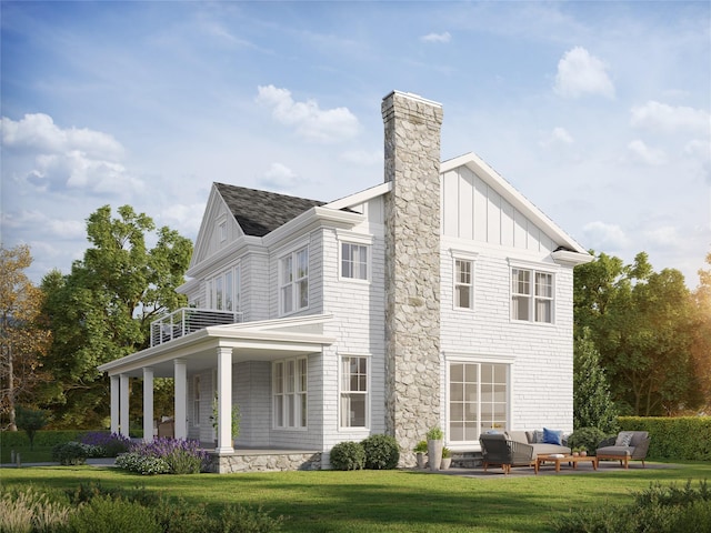 view of side of home featuring a balcony, roof with shingles, an outdoor living space, a lawn, and board and batten siding