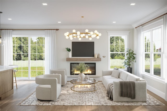 living area featuring baseboards, a glass covered fireplace, wood finished floors, crown molding, and a notable chandelier