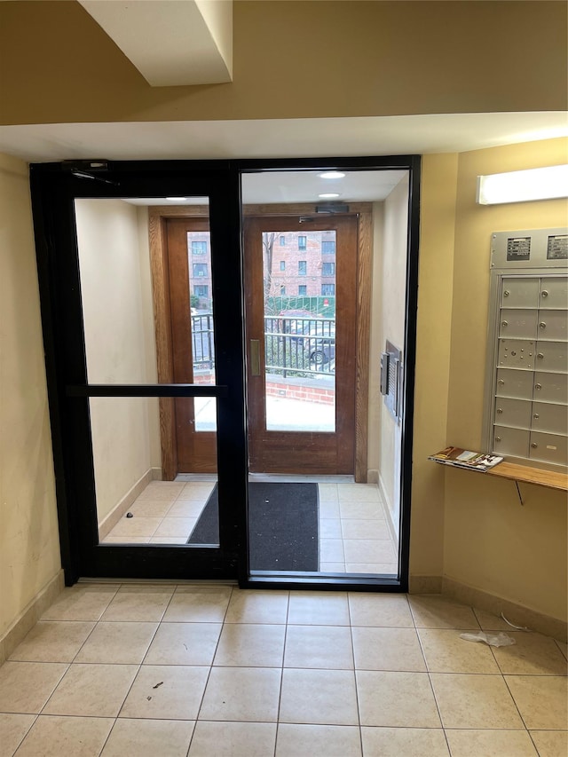 doorway to outside with light tile patterned flooring and a mail area