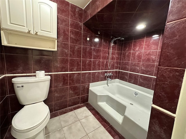 full bathroom featuring toilet, tile patterned floors, tile walls, and shower / bathtub combination