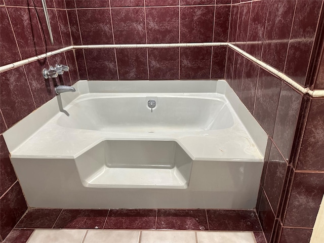 bathroom with a bathtub and tile patterned flooring