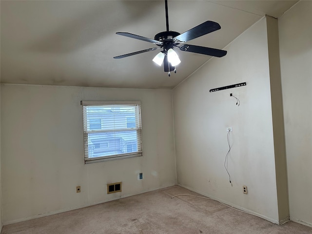 unfurnished room featuring lofted ceiling, ceiling fan, visible vents, and light colored carpet