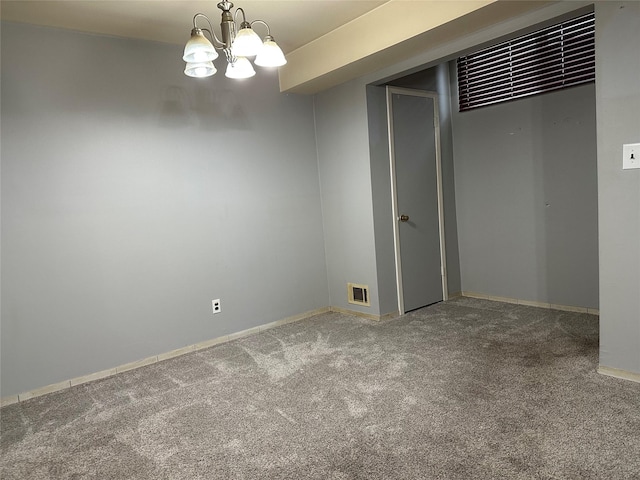 interior space featuring baseboards, visible vents, and a chandelier