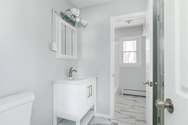 bathroom with vanity, toilet, and a baseboard heating unit