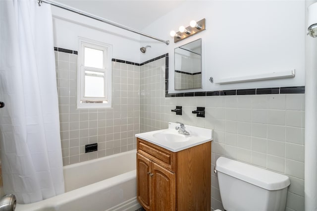 full bathroom with toilet, shower / bath combination with curtain, vanity, and tile walls