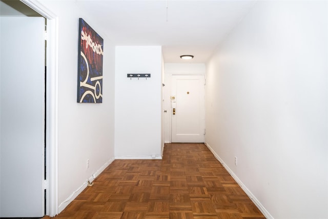 hallway featuring baseboards