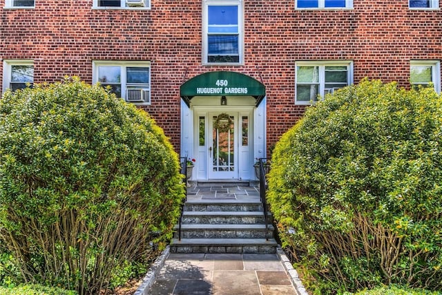 view of exterior entry with brick siding