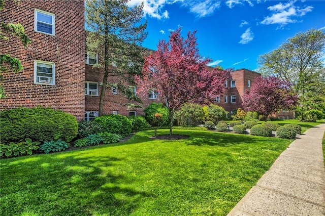 view of property's community with a lawn