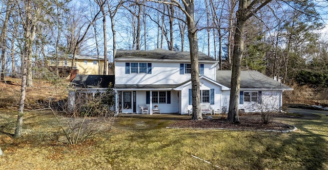 traditional-style home with a front lawn