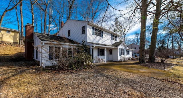 view of front of property with driveway and a chimney