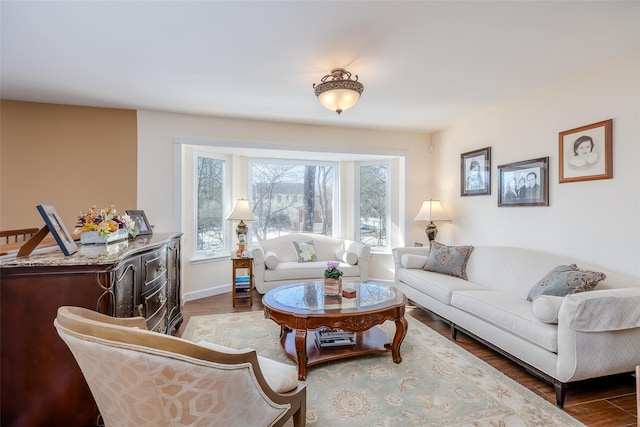 living area with wood finished floors and baseboards