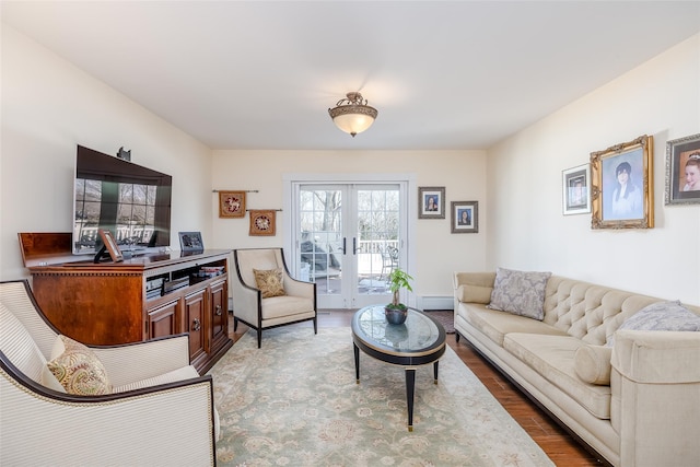 living room featuring french doors, baseboard heating, and wood finished floors