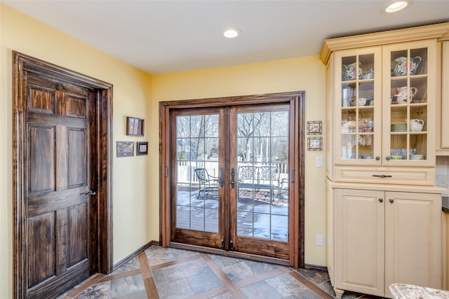 entryway with baseboards, french doors, and recessed lighting